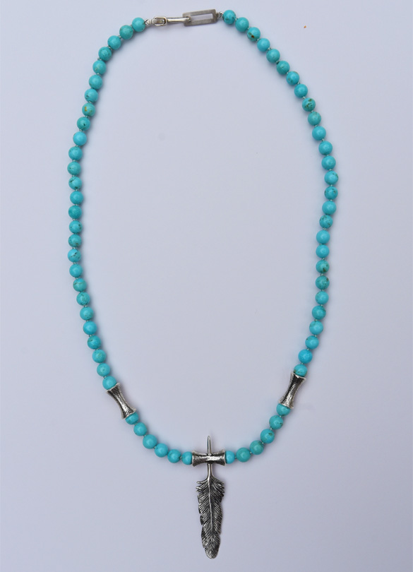 A single feather and flute motif in 925 cast silver as center piece of a necklace with a combinated of Ag 925 flutes and Arizona turquoise rounds