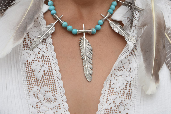 Five 925 cast silver differently sized feather and flute motifs combined with Arizona turquoise rounds